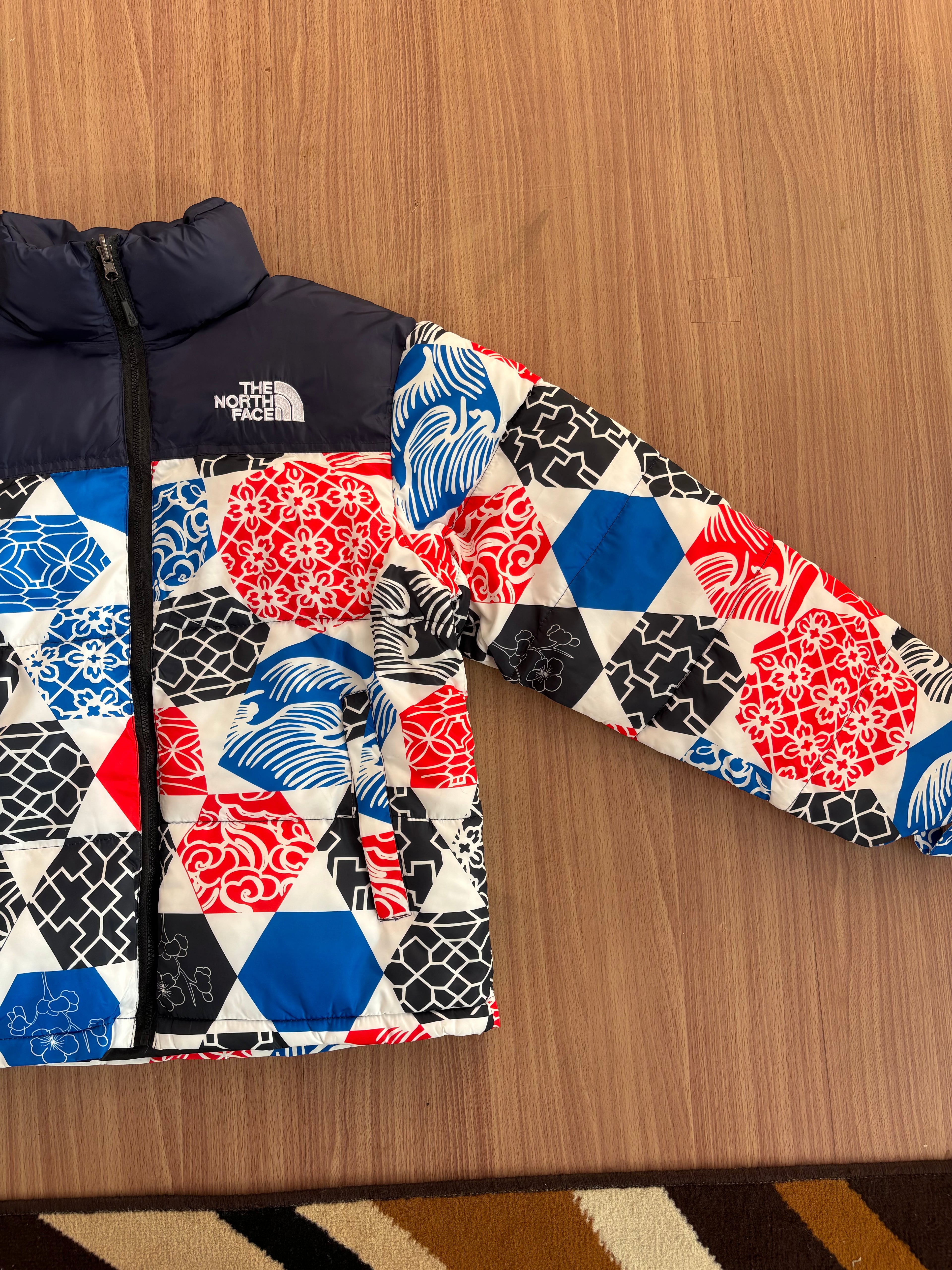 TNF 1996 Retro Nuptse Jacket in the Blue IC Geo Print