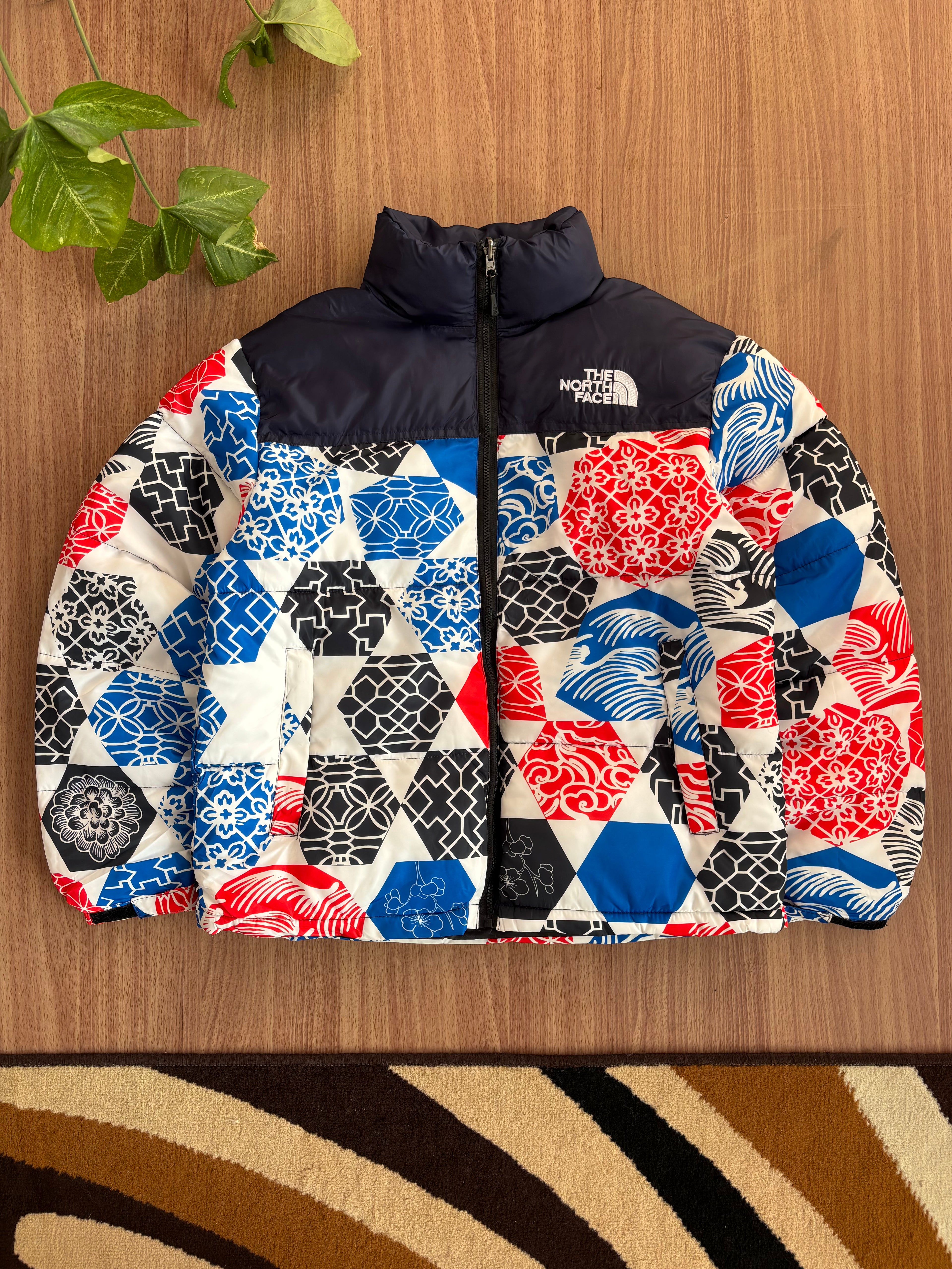 TNF 1996 Retro Nuptse Jacket in the Blue IC Geo Print